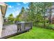 Spacious back deck with outdoor seating and grill overlooks a well-maintained, tree-lined backyard at 6257 Old Barn Ct, Indianapolis, IN 46268