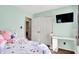 This bedroom features mint walls, a mounted television, and a built-in desk, offering a cozy and functional space at 6257 Old Barn Ct, Indianapolis, IN 46268