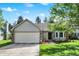Charming single-story home boasts a well-manicured lawn and attached two-car garage, offering both curb appeal and convenience at 6257 Old Barn Ct, Indianapolis, IN 46268