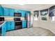 Updated kitchen features robin's egg blue cabinetry, black appliances and an eat-in nook with great lighting at 6257 Old Barn Ct, Indianapolis, IN 46268