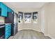 Kitchen nook features black-and-white patterned cafe curtains and ceramic tiled floors, with plenty of light at 6257 Old Barn Ct, Indianapolis, IN 46268