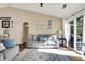 Comfortable living room with a plush sofa, sliding door to the outdoors, and ample natural light, creating a relaxing ambiance at 6257 Old Barn Ct, Indianapolis, IN 46268