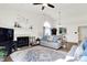 Cozy living room with fireplace and ceiling fan, offering a comfortable space for relaxation and entertainment at 6257 Old Barn Ct, Indianapolis, IN 46268