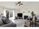 Bright living room featuring a fireplace, ceiling fan, and sliding glass doors to the outside at 6257 Old Barn Ct, Indianapolis, IN 46268