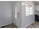Bright entryway features a window, white door, light-grey walls and durable vinyl floors at 6638 Sunbury Dr, Indianapolis, IN 46241