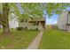 Charming two-story home featuring a well-maintained lawn and a welcoming walkway to the front door at 6638 Sunbury Dr, Indianapolis, IN 46241