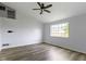 Bright living room features a window, laminate floors, ceiling fan, and neutral paint at 6638 Sunbury Dr, Indianapolis, IN 46241