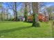 Spacious backyard showcasing a green lawn and a wooden deck, perfect for outdoor entertaining at 7002 N Ralston Ave, Indianapolis, IN 46220