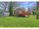 Backyard features a wooden deck with stairs and a well-maintained green lawn at 7002 N Ralston Ave, Indianapolis, IN 46220