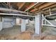 Unfinished basement with exposed pipes, block walls, and concrete pillars awaiting customization at 7002 N Ralston Ave, Indianapolis, IN 46220