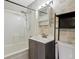 A full bathroom showcasing a shower-tub combo, tile surround, and modern vanity at 7002 N Ralston Ave, Indianapolis, IN 46220