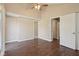 This carpeted bedroom has a ceiling fan, and is lit by natural light from the windows at 7002 N Ralston Ave, Indianapolis, IN 46220
