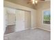 A spacious bedroom features carpet floors, a sliding door closet, and natural light at 7002 N Ralston Ave, Indianapolis, IN 46220