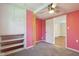 View of a second bedroom with carpet floors, a ceiling fan and built in storage shelving at 7002 N Ralston Ave, Indianapolis, IN 46220