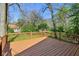 Exterior view of a wooden deck with wood railing overlooking a tree-filled backyard at 7002 N Ralston Ave, Indianapolis, IN 46220