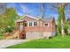 Charming brick home with a well-maintained yard, inviting entrance, and foundation at 7002 N Ralston Ave, Indianapolis, IN 46220