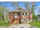 Charming brick home with a gravel driveway, concrete block foundation, and a small front yard at 7002 N Ralston Ave, Indianapolis, IN 46220