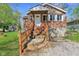 Charming brick home featuring a covered front entry and lovely landscaped front yard at 7002 N Ralston Ave, Indianapolis, IN 46220