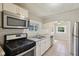 Well-equipped kitchen with modern appliances, ample counter space, and a view to the breakfast nook at 7002 N Ralston Ave, Indianapolis, IN 46220