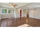 Spacious living room with hardwood floors, a ceiling fan and natural light through multiple windows at 7002 N Ralston Ave, Indianapolis, IN 46220