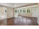 Inviting living room with beautiful wood floors, a ceiling fan, and sun-filled windows at 7002 N Ralston Ave, Indianapolis, IN 46220