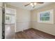 A living room featuring wood floors, a ceiling fan and natural lighting from a nearby window at 7002 N Ralston Ave, Indianapolis, IN 46220