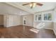Bright living room featuring wood floors, a ceiling fan, and archway to the adjacent kitchen at 7002 N Ralston Ave, Indianapolis, IN 46220