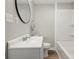 Bathroom showcases a white vanity, round mirror, and a clean, tiled shower and tub combo at 717 S A St, Elwood, IN 46036