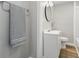 Bathroom features a white vanity, modern fixtures, and a gray towel for a fresh, clean look at 717 S A St, Elwood, IN 46036