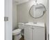 Bathroom shows a well-lit white vanity, and a round mirror providing a fresh, clean feel at 717 S A St, Elwood, IN 46036