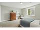 Well-lit bedroom with dresser, bed, chair, and a window with outside greenery views at 717 S A St, Elwood, IN 46036