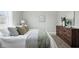 Cozy bedroom showcasing soft bedding, an artful accent wall, and handsome wood dresser at 717 S A St, Elwood, IN 46036