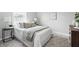 Bedroom features a bed with white comforter, side table, and soft natural light at 717 S A St, Elwood, IN 46036