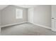 Empty bedroom shows great natural light and new carpet, creating a blank canvas at 717 S A St, Elwood, IN 46036
