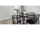 Dining room with a black table and black chairs, wood-look floors and view of kitchen at 717 S A St, Elwood, IN 46036