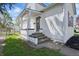 Inviting home entrance with freshly painted stairs and trim and manicured lawn at 717 S A St, Elwood, IN 46036