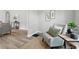 Inviting sitting room with cozy chair and side table, light paint, and new flooring at 717 S A St, Elwood, IN 46036