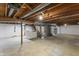 Unfinished basement with exposed ceiling beams and utilities, ready for customization at 7412 Hiner Ln, Indianapolis, IN 46219