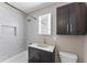 Updated bathroom with modern vanity, stylish fixtures, and tiled shower and bath at 7412 Hiner Ln, Indianapolis, IN 46219