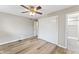 Bedroom featuring hardwood floors, large closet and a modern ceiling fan at 7412 Hiner Ln, Indianapolis, IN 46219