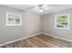 Sunny bedroom with natural light, two windows and hardwood floors at 7412 Hiner Ln, Indianapolis, IN 46219