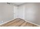 Bedroom highlighting wood laminate floors, a bi-fold closet, and a neutral color palette at 7412 Hiner Ln, Indianapolis, IN 46219