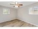 Cozy bedroom with two windows providing natural light, complemented by hardwood floors at 7412 Hiner Ln, Indianapolis, IN 46219