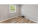 Bedroom featuring hardwood floors, a window bringing in natural light, and neutral wall color at 7412 Hiner Ln, Indianapolis, IN 46219