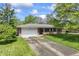 Charming brick ranch home with a two-car garage and a well-manicured front lawn at 7412 Hiner Ln, Indianapolis, IN 46219