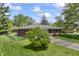 Inviting single-story brick home with a well-maintained lawn and mature trees in the yard at 7412 Hiner Ln, Indianapolis, IN 46219