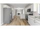 Kitchen featuring a view of the open concept living space with a brick fireplace and stainless steel refrigerator at 7412 Hiner Ln, Indianapolis, IN 46219