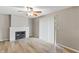 Inviting living room with a classic brick fireplace, fan, hardwood flooring, and sliding glass door to outdoor at 7412 Hiner Ln, Indianapolis, IN 46219