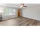 Bright living room with hardwood floors, a large window, and unique front door at 7412 Hiner Ln, Indianapolis, IN 46219