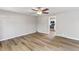 Spacious living room featuring hardwood floors and a ceiling fan with views of the kitchen at 7412 Hiner Ln, Indianapolis, IN 46219
